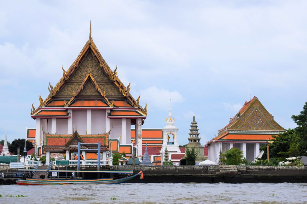 A Buddhist temple sits next to the Chao Phraya River in Thonburi, Bangkok, Thailand