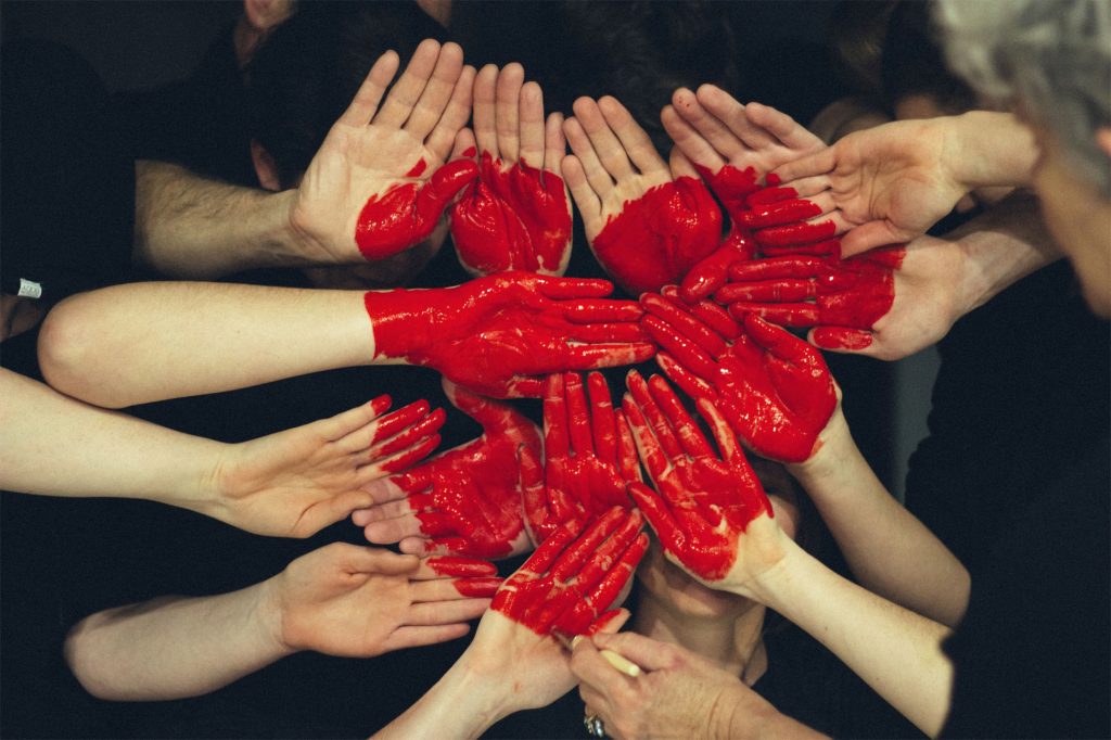 Volunteers form a heart with their hands whilst on duty in Thailand