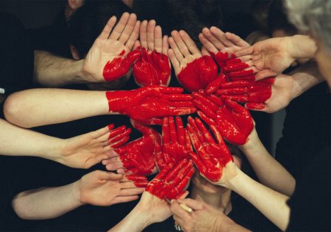 Volunteers form a heart with their hands whilst on duty in Thailand