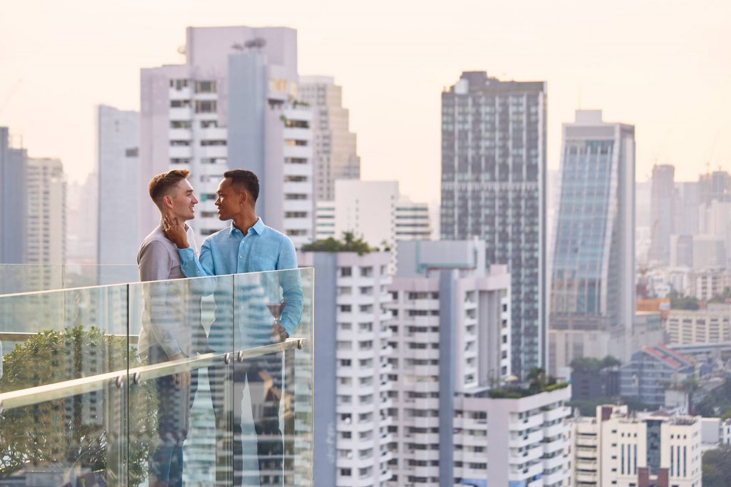 Two gay lovers at a rooftop bar in Bangkok.