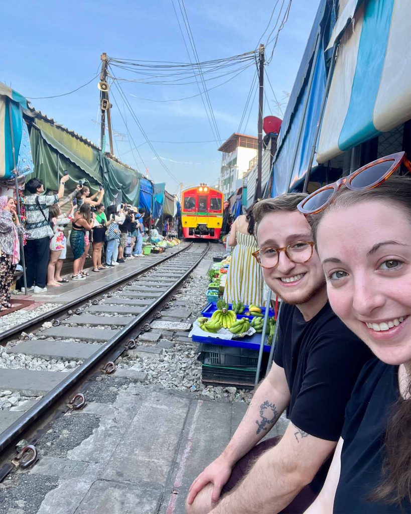 Newlyweds Ilana and Ren exploring the Maeklong Railway Market.