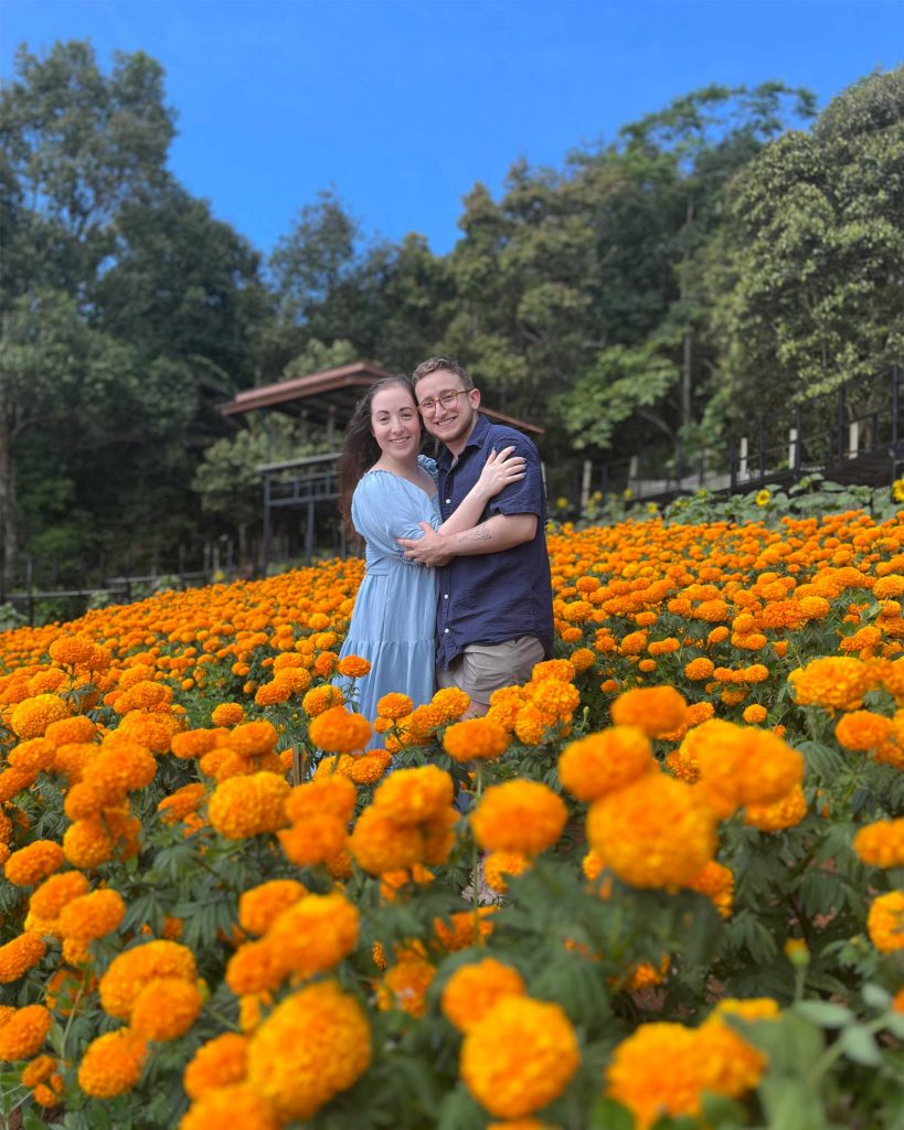 Ilana and Ren walk through fields of bright orange flowers in Mon Jam. 