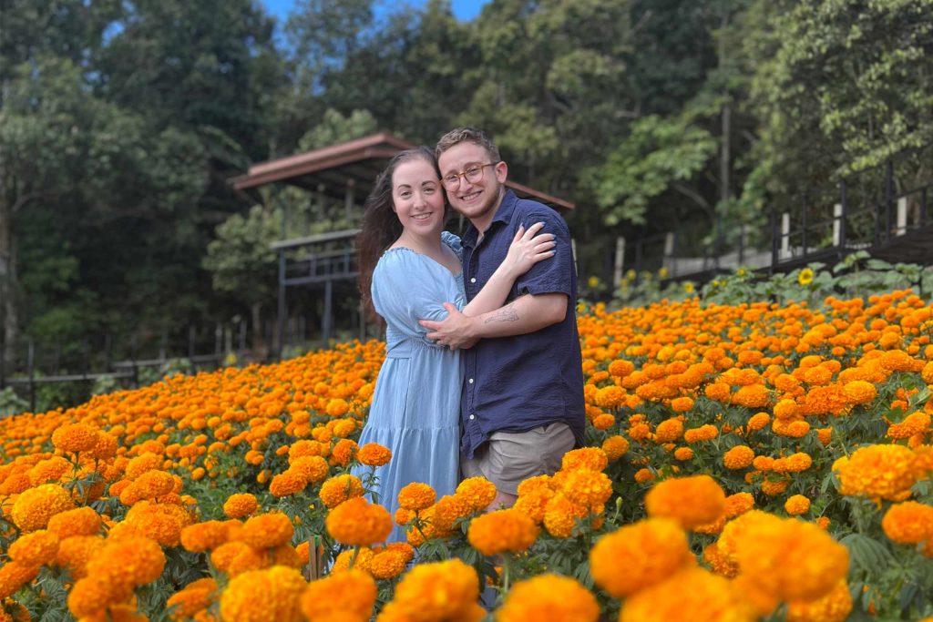 Ilana and Ren walk through fields of bright orange flowers in Mon Jam.