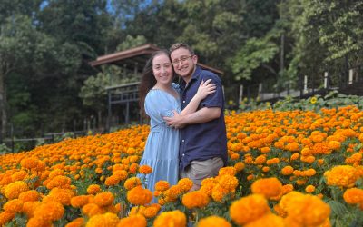 Ilana and Ren walk through fields of bright orange flowers in Mon Jam.