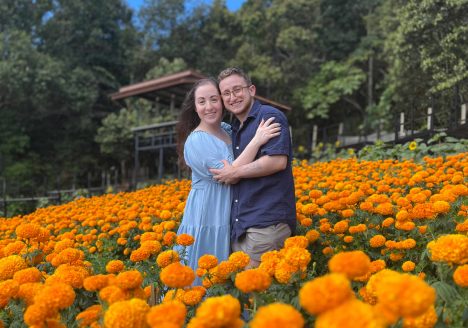 Ilana and Ren walk through fields of bright orange flowers in Mon Jam.