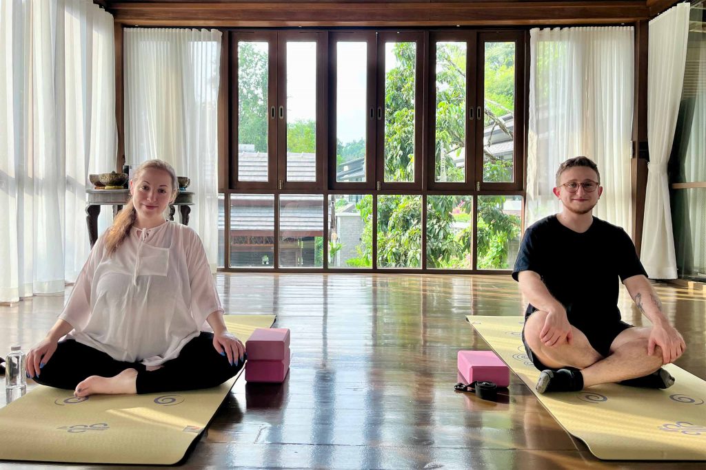 Newlyweds trying yoga at the Aleenta Retreat Chiang Mai spa.