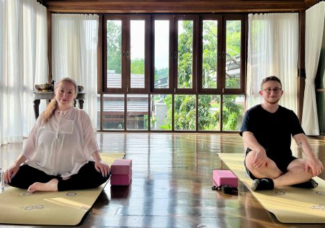 Newlyweds trying yoga at the Aleenta Retreat Chiang Mai spa.