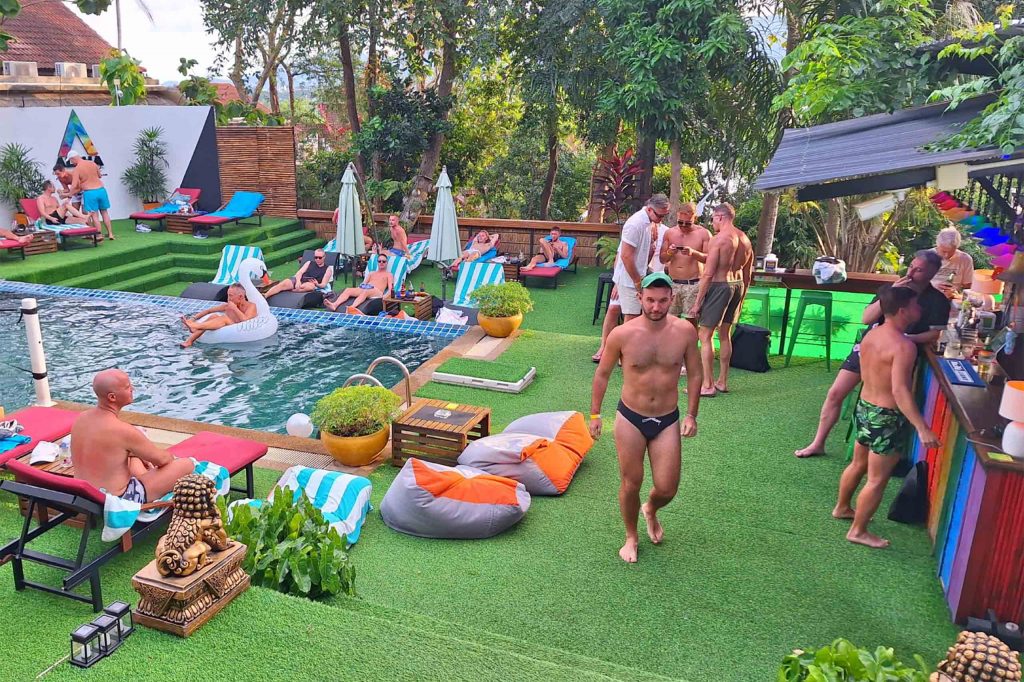 A group of gay men chillout poolside at Alpha Gay Resort, Koh Samui.