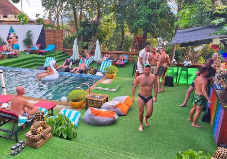 A group of gay men chillout poolside at Alpha Gay Resort, Koh Samui.