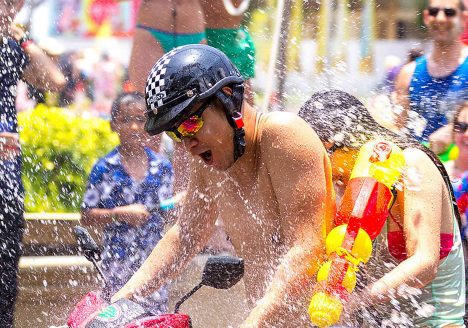 Man on motorbike drenched during Songkran festival