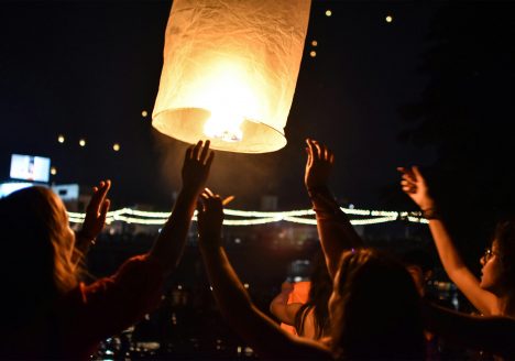 A lantern being lifted into the sky during Yi Peng in Chiang Mai.