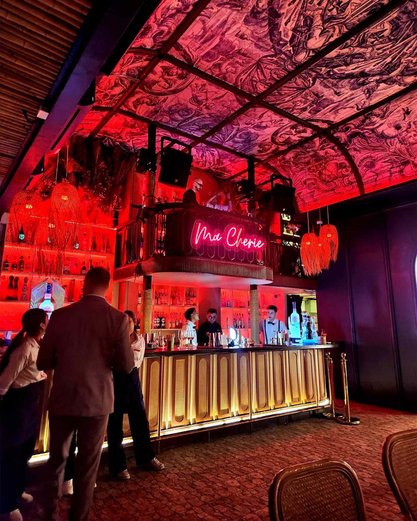 vibrant red ceiling and bar at Pastel rooftop bar. It's a must-visit for those spending one day in Bangkok.