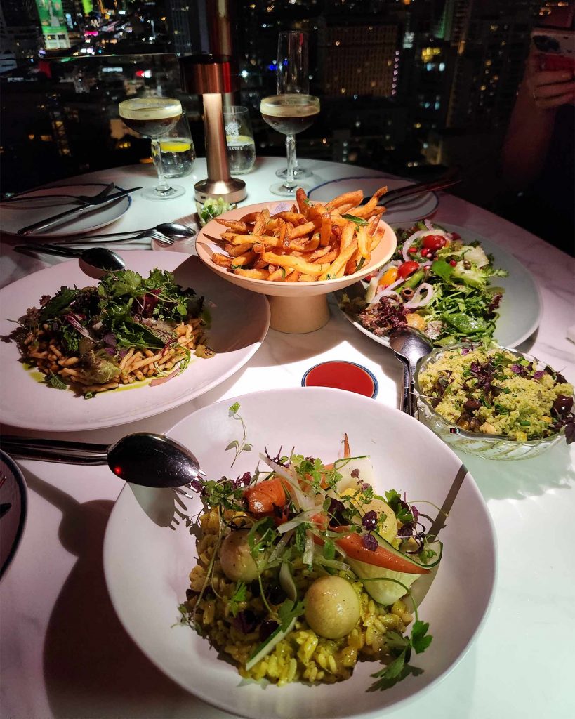 A platter of Mediterranean food on a white table.