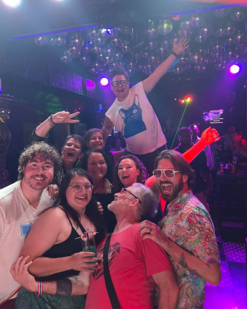 Queer Connect group at a bar in Chiang Mai posing for a photo.