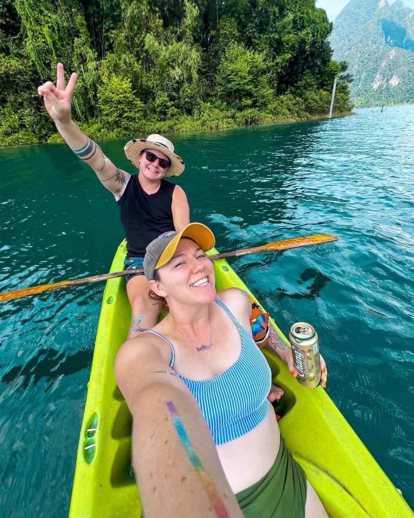 Korbyn and Janni, founders of Queer Connect, sitting on a boat in Thailand.