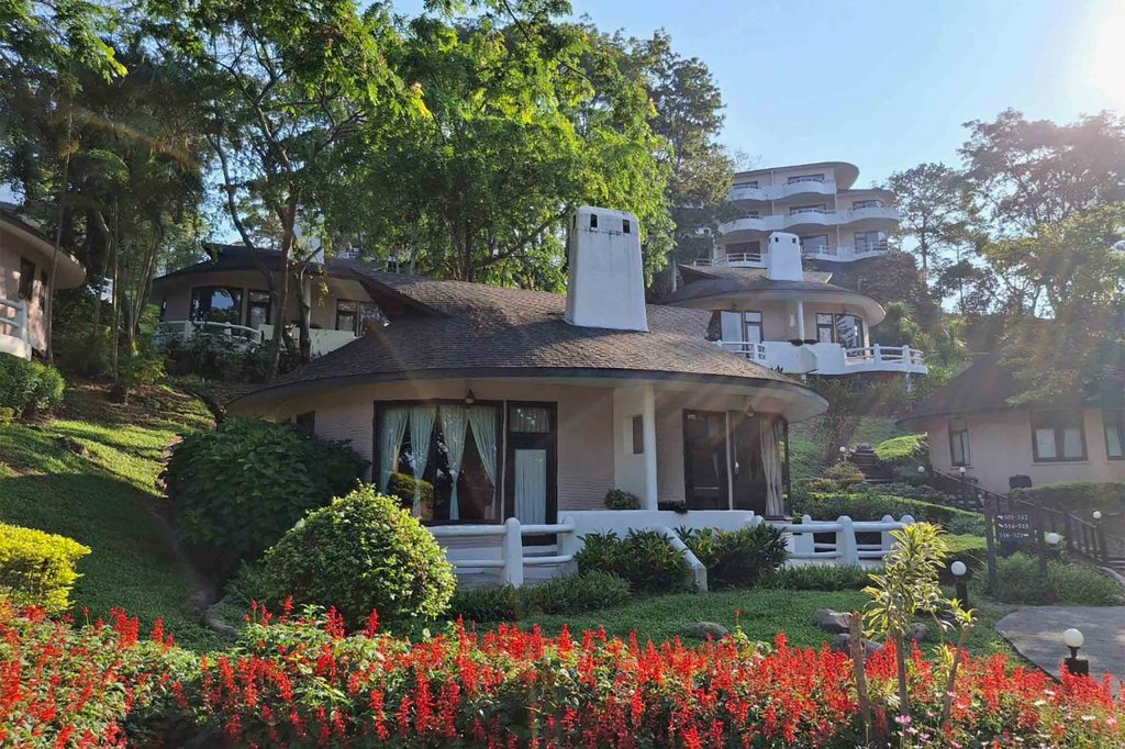 Quaint Swiss-style lodges surrounded by plants.