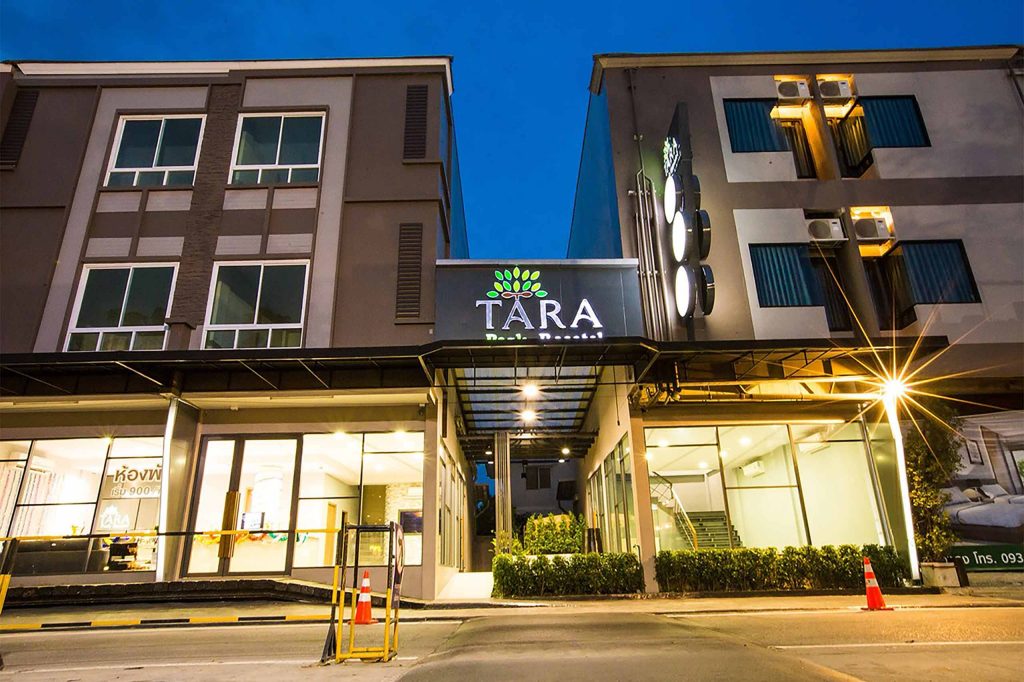 Exterior of a modern hotel on a road.