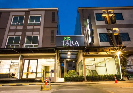 Exterior of a modern hotel on a road.
