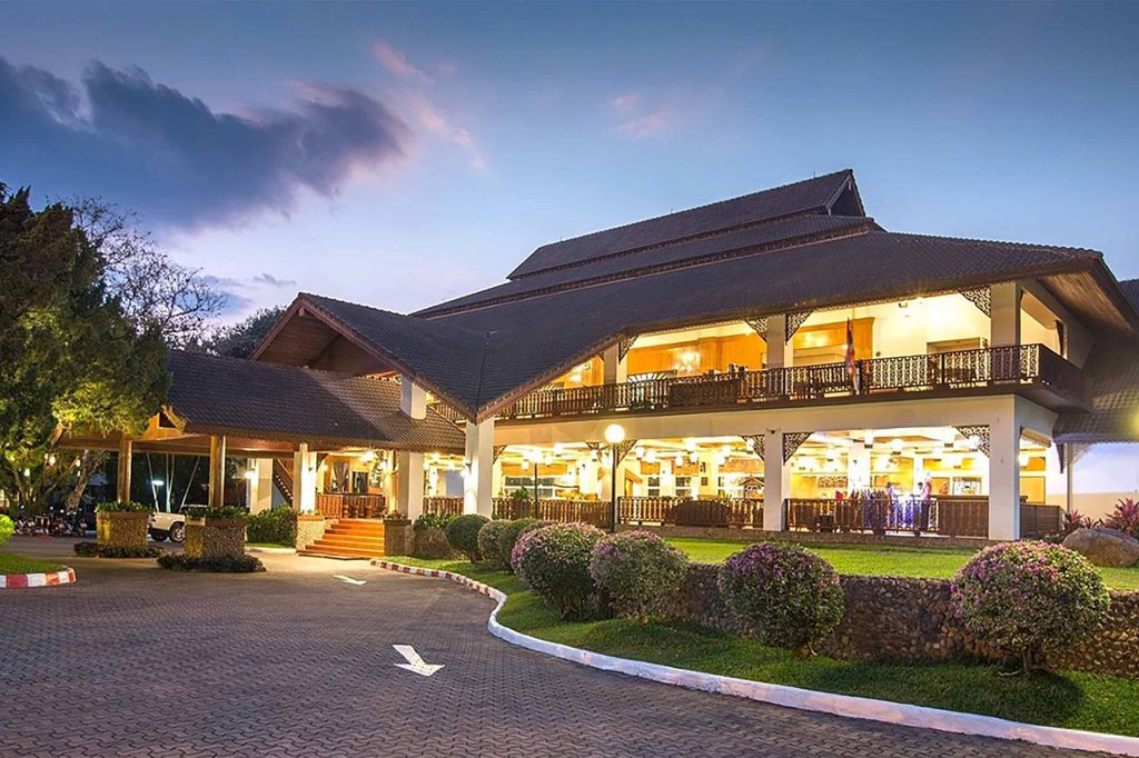 Exterior of brightly lit resort at twilight.