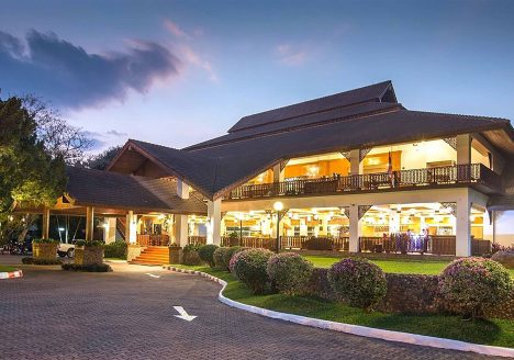 Exterior of brightly lit resort at twilight.