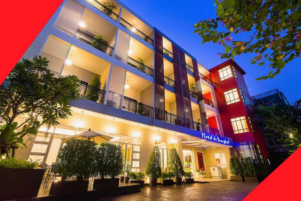 Hotel balconies lit up at night.