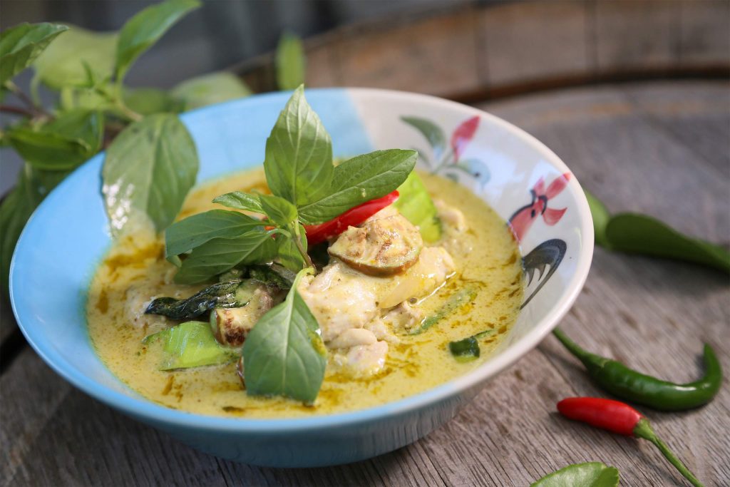 A bowl of creamy green curry with chicken, Thai basil, aubergine and fresh chillies. A regional Thai Food everyone should try.