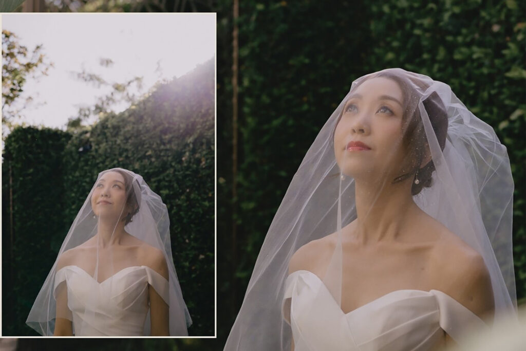 A bride is being photographed in a garden in Thailand.