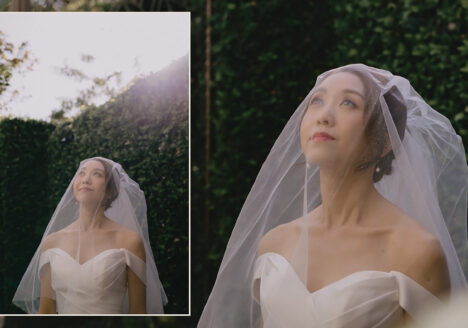 A bride is being photographed in a garden in Thailand.